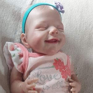 Smiling Reborn Baby Doll with Pink Outfit and Headband